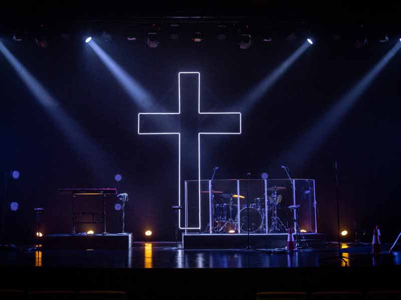 Easy church stage setup with LED lighted cross as backdrop